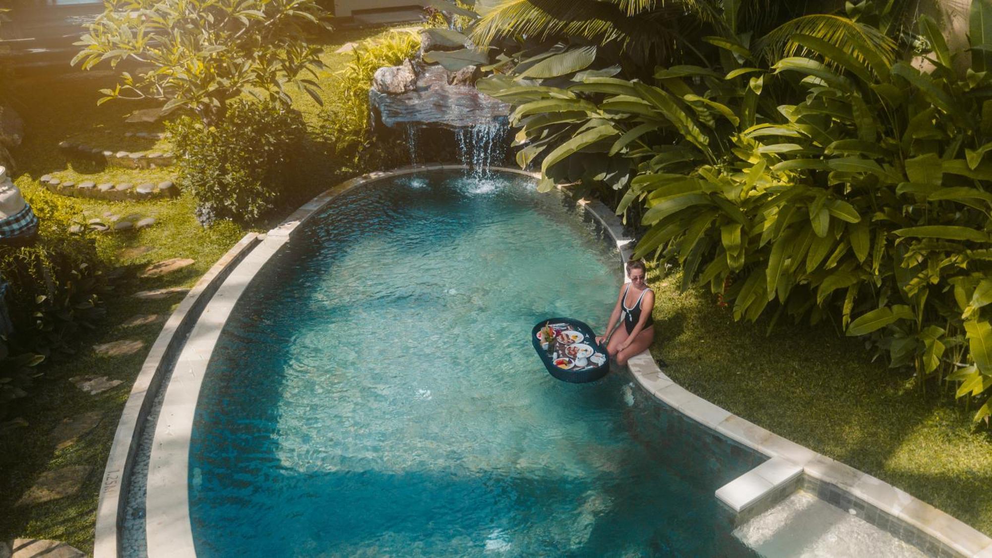 우붓 뉴 발리 리조트&스파 외부 사진 A woman floating in a pool